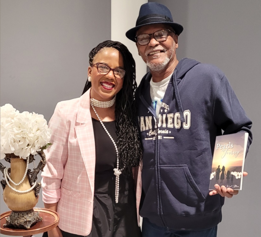 Kaiyah with colleague holding book