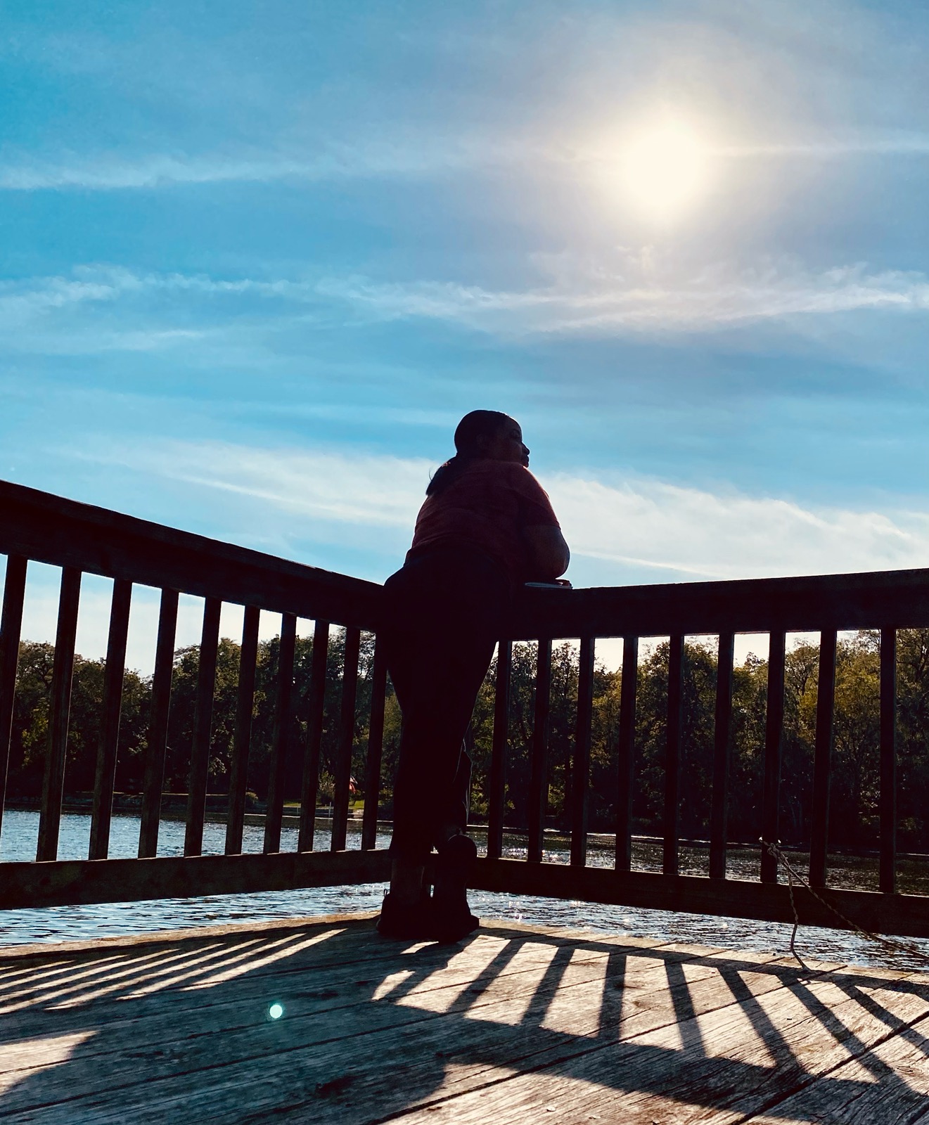 Silhouette at sunset overlooking water